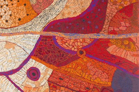 A detail view of a work made in earth tones, purples and oranges.