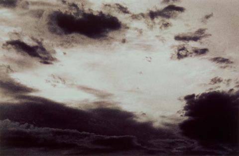 Sepia toned photograph of cloudy dark sky