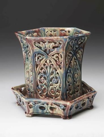 Artwork Pierced jardiniere and stand this artwork made of Earthenware slab built and elaborately pierced with palmette motifs, created in 1934-01-01