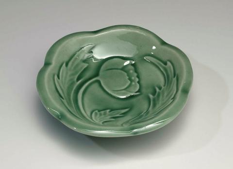 Artwork Butter dish this artwork made of Earthenware, hand-built white clay with six lobed rim carved with a floral motif and glazed green, created in 1954-01-01