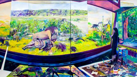 A painting of a person painting a large, bright painting of a lion hunting zebra.