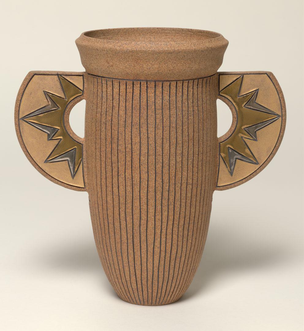 Artwork Winged vase:  Sunburst this artwork made of Reddish buff stoneware clay, wheelthrown in tall calyx shape incised with lines. The lugs with silver and gold details and the interior glazed brown, created in 1990-01-01