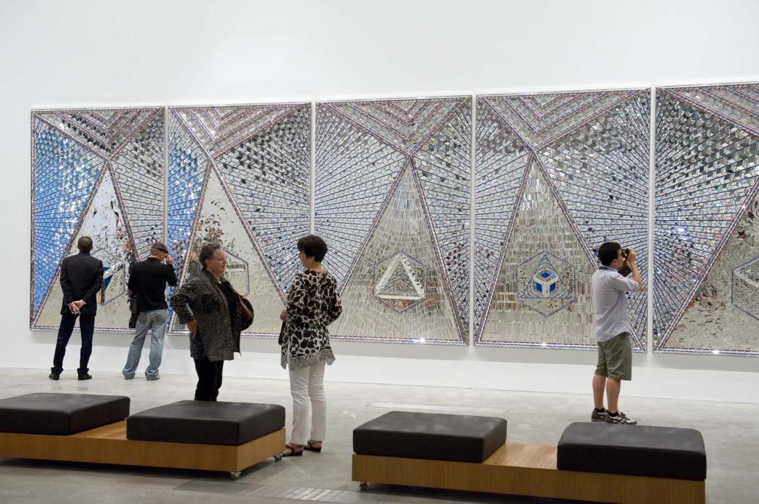 An installation view of a large mirrored mosaic work.